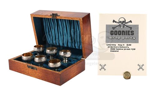Lot #308 - THE GOONIES (1985) - Treasure Coin, Goblet Set and Wrap Party Invitation