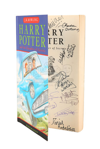 Lot #318 - HARRY POTTER AND THE CHAMBER OF SECRETS (2002) - Daniel Radcliffe and Cast Autographed Paperback Book