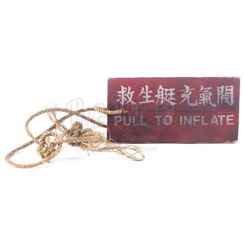 Lot # 772: INDIANA JONES & THE TEMPLE OF DOOM (1984) - Indiana Jones' (Harrison Ford) Screen-Matched "Pull To Inflate" Life Raft Tag