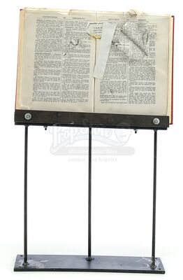 Lot # 59: Episode "Ancient Death Ray" (2004, E16): Book with Bullet Hole and Display Stand