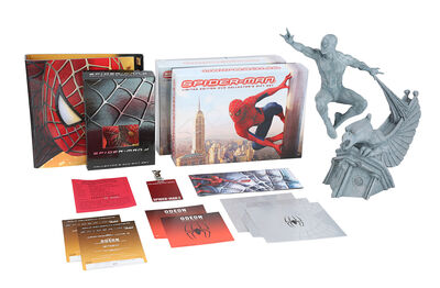 Lot #883 - SPIDER-MAN TRILOGY (2002 - 2007) - Sam Raimi-autographed DVD Box and Photo, Tobey Maguire-autographed Invitation and Photo, and Crew Gifts