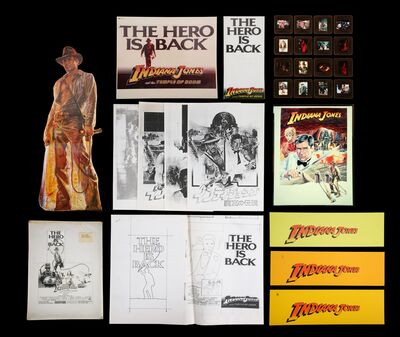 Lot #349 - INDIANA JONES AND THE TEMPLE OF DOOM (1984) - Poster Concept Transparency, Layout Compositions, 23 Production Sides, and Various Press Items