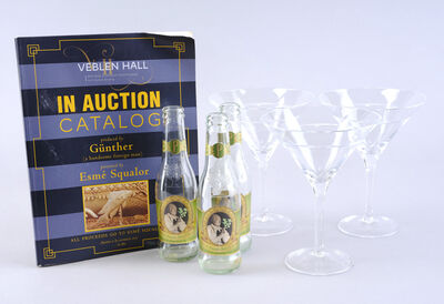 Lot # 102: Netflix's A Series of Unfortunate Events (TV Series) - Esme Squalor's Penthouse Parsley Soda Bottles and Martini Glasses with Auction Book