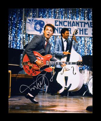 Lot #232 - BACK TO THE FUTURE (1985) - Michael J. Fox Autographed Photograph with Guitar