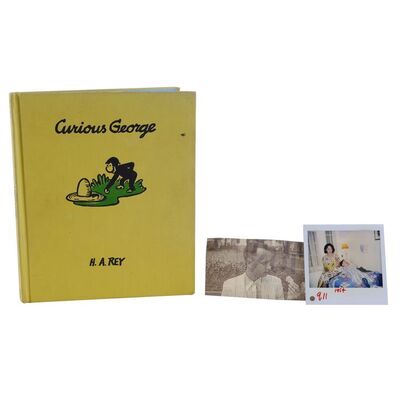 Lot # 127: Forrest Gump (1994) - Forrest Gump's (Tom Hanks) "Curious George" Book, Feather, and Polaroid of Mrs. Gump (Sally Field)