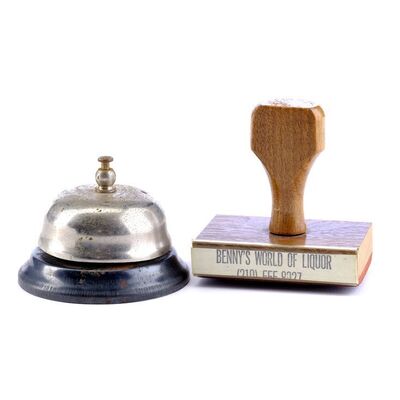 Lot # 751: From Dusk Till Dawn (1996) - Dew Drop Motel Concierge Bell and Benny's World of Liquor Rubber Stamp
