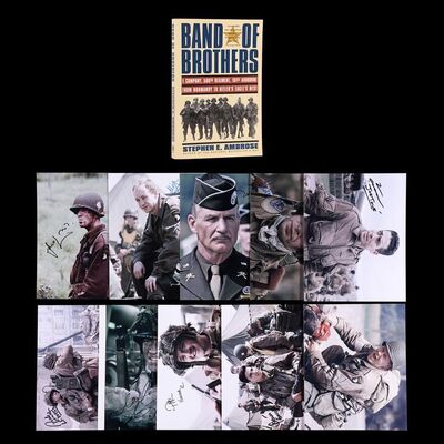 Lot #23 - BAND OF BROTHERS (T.V. MINI SERIES, 2001) - Tom Hanks Autographed Paperback Book and Autographed Cast Photos
