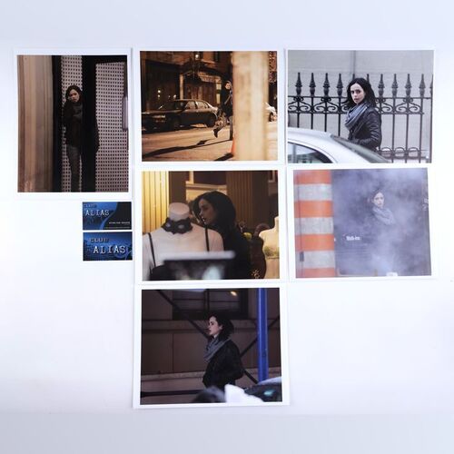 Lot #397: MARVEL'S JESSICA JONES (T.V. SERIES, 2015 - 2019) - Six Malcolm Ducasse Surveillance Photos of Jessica Jones with Two Alias Business Cards