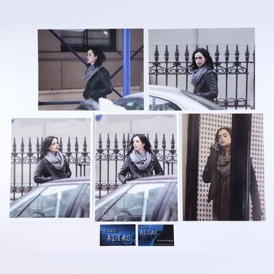 Lot #458: MARVEL'S JESSICA JONES (T.V. SERIES, 2015 - 2019) - Five Malcom Ducasse Surveillance Photos of Jessica Jones with Two Club Alias Business Cards