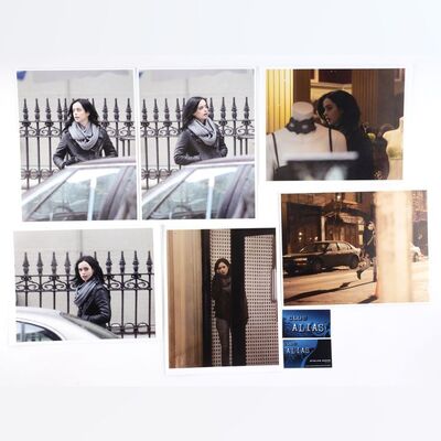 Lot #498: MARVEL'S JESSICA JONES (T.V. SERIES, 2015 - 2019) - Six Malcolm Ducasse Surveillance Photos of Jessica Jones with Two Club Alias Business Cards
