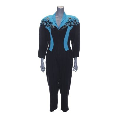 Lot # 92: Beverly Goldberg's (as played by Wendi McLendon-Covey) "Push It" Black and Blue Jumpsuit with "B" Necklace