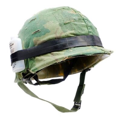Lot #790 - Private Cowboy's (Arliss Howard) Helmet Cover with Insect Repellent Bottle and Vietnam-Era Helmet ### FULL METAL JACKET (1987)