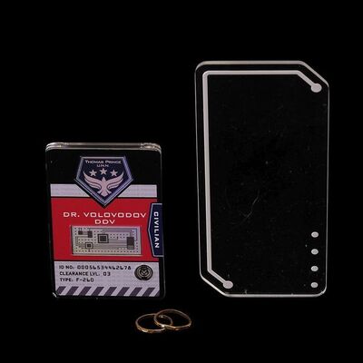 Lot # 128: Anna Volovodov's (Elizabeth Mitchell) Badge with Comm Device and Wedding Rings