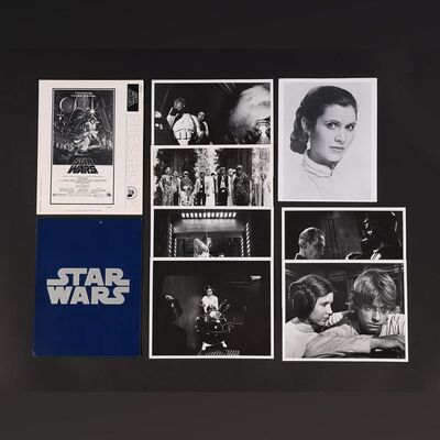 Lot #472 - STAR WARS: A NEW HOPE (1977) - Cast-and-crew Screening Ticket, Press Book and Synopsis, Seven Stills and Collection of Newspaper Clippings, 1977