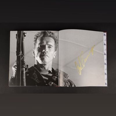 Lot #546 - THE TERMINATOR (1984) AND TERMINATOR 2: JUDGMENT DAY (1991) - Two Terminator Vault Books (English and Spanish) Autographed by Arnold Schwarzenegger, Robert Patrick and Kristanna Loken