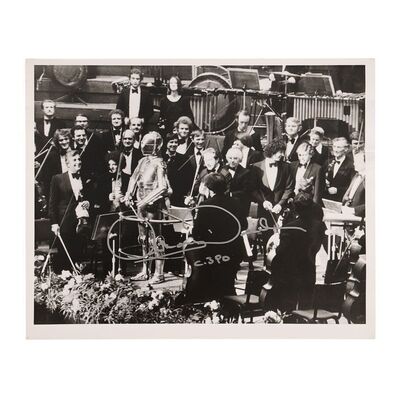 Lot #744: STAR WARS: VARIOUS PRODUCTIONS - Anthony Daniels Collection: Autographed Black-and-white Photo of C-3PO (Anthony Daniels) and the London Symphony Orchestra