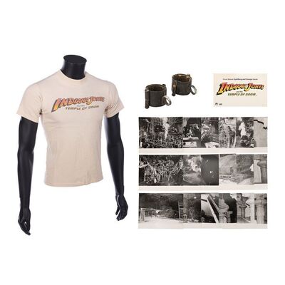 Lot #1217: INDIANA JONES AND THE TEMPLE OF DOOM (1984) - Shackles, Photographs, Screening Invite and Crew T-shirt