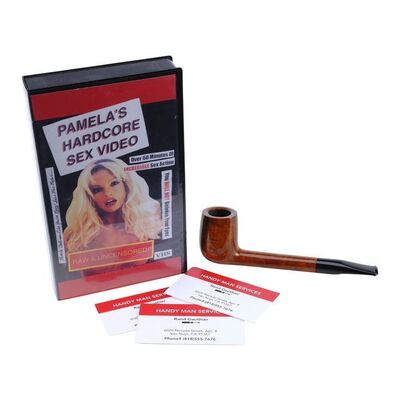Lot #1466 - Milton "Uncle Miltie" Ingley's (Nick Offerman) Pipe and Rand Gauthier's (Seth Rogen) Business Cards with "Pamela's Hardcore Sex Video" Tape ### PAM & TOMMY (2022)