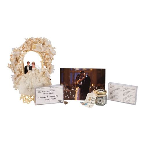 Lot #148: Luther (Tom Hopper) and Sloane's (Genesis Rodriguez) Wedding Cake Topper, Ring and Accessories ### UMBRELLA ACADEMY, THE (2019 - 2024)