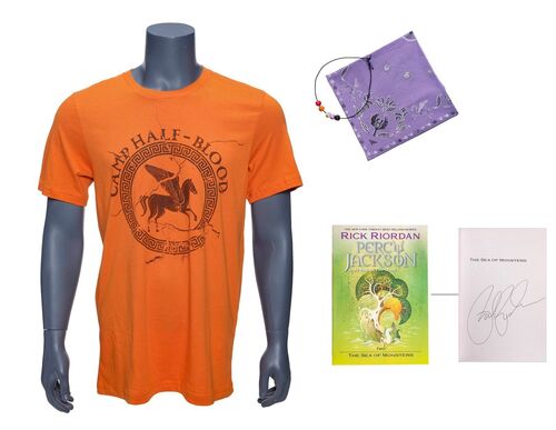 Lot #28: "Character Signed" Camp Half-Blood T-Shirt, Necklace, Bandana and Rick Riordan-Signed Book ### PERCY JACKSON AND THE OLYMPIANS (2023 - PRESENT)