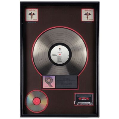 231. MOTLEY CRUE - Dr. Feelgood Double Platinum Disc Award Presented to John Lassman