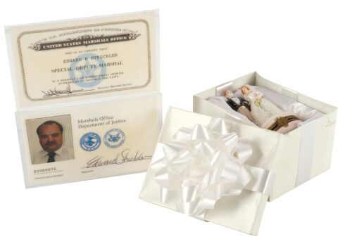 675. Mike Papac Collection: Allison's (Mary Ellen Trainor) Decorative Wedding Figurine in Gift Box with Pair of Air Marshal (Richard Riehle) IDs ### EXECUTIVE DECISION (1996)