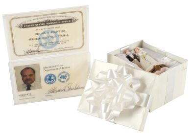 675. Mike Papac Collection: Allison's (Mary Ellen Trainor) Decorative Wedding Figurine in Gift Box with Pair of Air Marshal (Richard Riehle) IDs ### EXECUTIVE DECISION (1996)