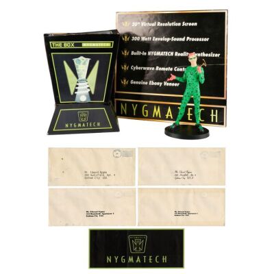 56. Dr. Edward Nygma's (Jim Carrey) Nygmatech Box, Signs, and Gotham City Envelopes with Warner Bros. Studio Store Riddler Statue ### BATMAN FOREVER (1995)