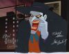 Lot # 11. The Joker Original Production Cel on Studio Printed Photographic Background Signed by Dan Riba, Kevin Altieri, Robert N. Skir, and Stan Berkowitz ### BATMAN: MASK OF THE PHANTASM (1993)