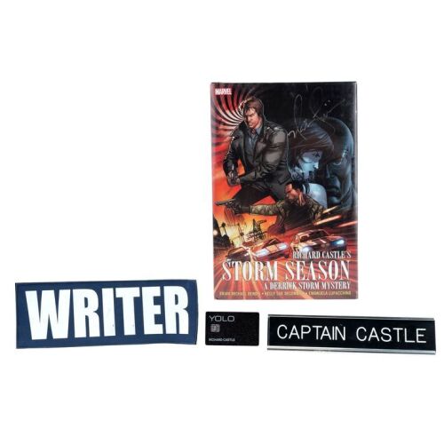 573. Richard Castle's (Nathan Fillion) "Writer" Patch, "Captain Castle" Nameplate, and "YOLO" Credit Card with Fillion-Autographed Richard Castle's Storm Season Graphic Novel ### CASTLE (T.V. SERIES, 2009 - 2016)