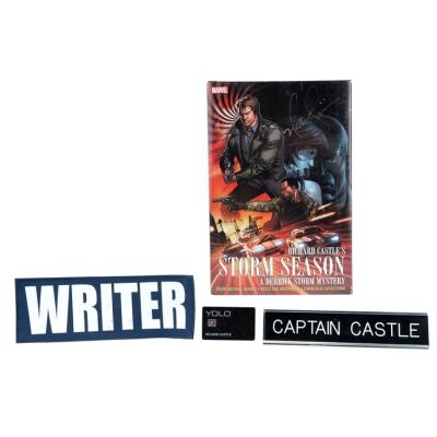 573. Richard Castle's (Nathan Fillion) "Writer" Patch, "Captain Castle" Nameplate, and "YOLO" Credit Card with Fillion-Autographed Richard Castle's Storm Season Graphic Novel ### CASTLE (T.V. SERIES, 2009 - 2016)