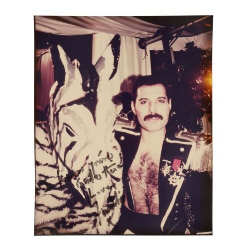 Lot # 296. The Reinhold Mack Collection: Freddie Mercury-Autographed Black and White Party Photograph ### QUEEN