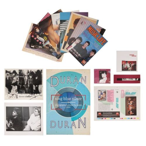 Lot # 483. The Denis O'Regan Collection: Band-Autographed EMI Print, One Unused Video Insert, Sealed Limited Edition Rio Two-Disk CD, CD Box Set, Video Insert Printers Proof, Simon Le Bon and John Taylor Bromide Vintage 1984 Print, and Sing Blue Silver B