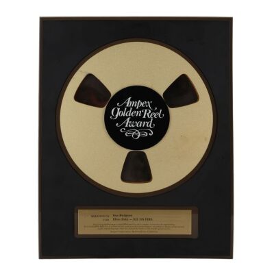 Lot # 492. Golden Reel Award Presented to Producer Gus Dudgeon for Elton John&rsquo;s Ice on Fire ### ELTON JOHN