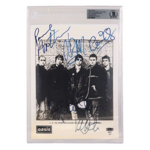 Lot # 603. Liam Gallagher, Paul Arthurs, Noel Gallagher, Paul McGuigan, and Alan White-Autographed Photo ### OASIS